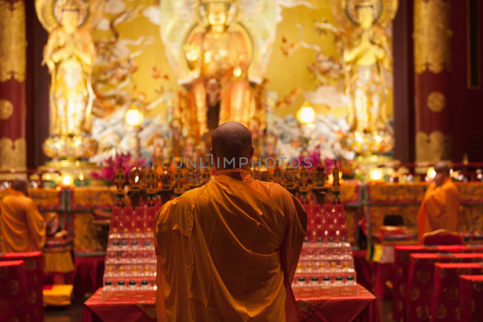 SINGAPORE - SEP 08: Monk chanting in Buddha tooth relic temple on Sep 08, 2013 in Singapore. Since opening in 2007, the temple has become a popular attraction within Chinatown.