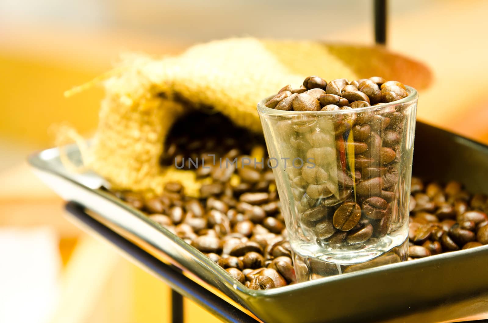 Fresh coffee beans on glass.