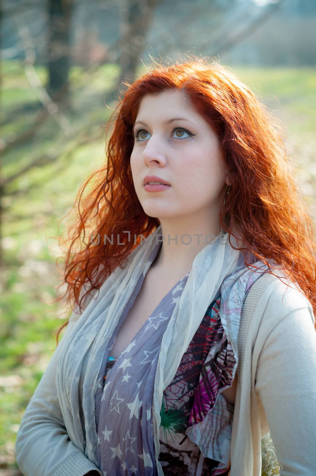beautiful young woman posing in the park of the city