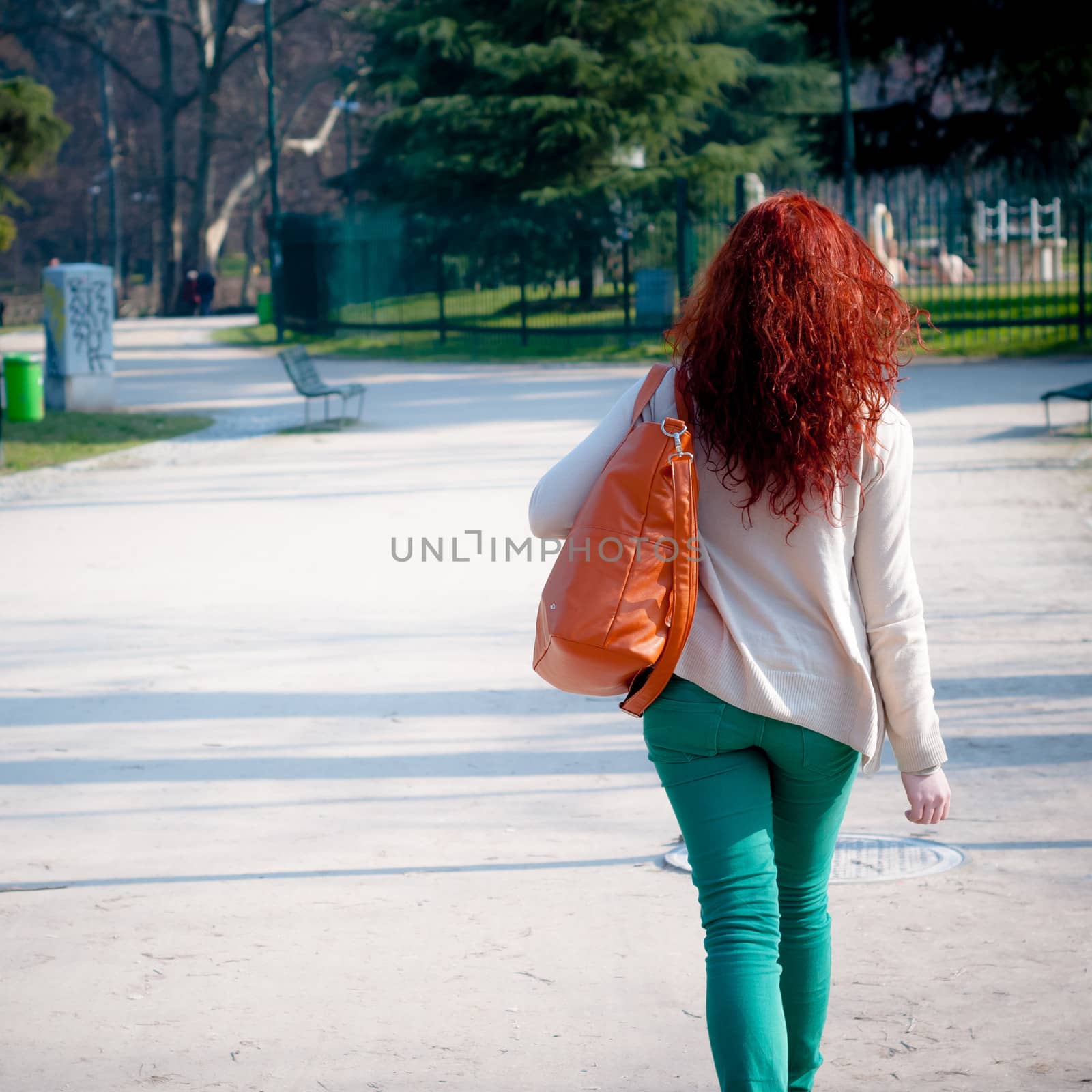 young woman walking by peus