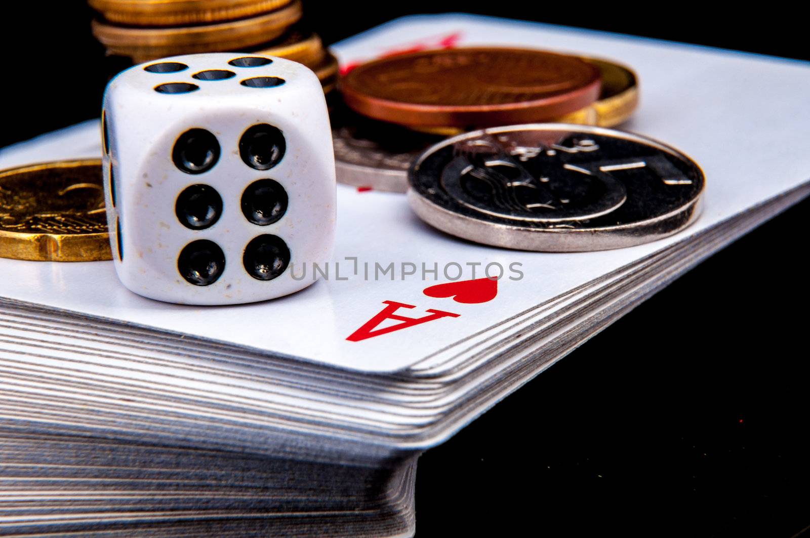 An image of playing cards, dice and money