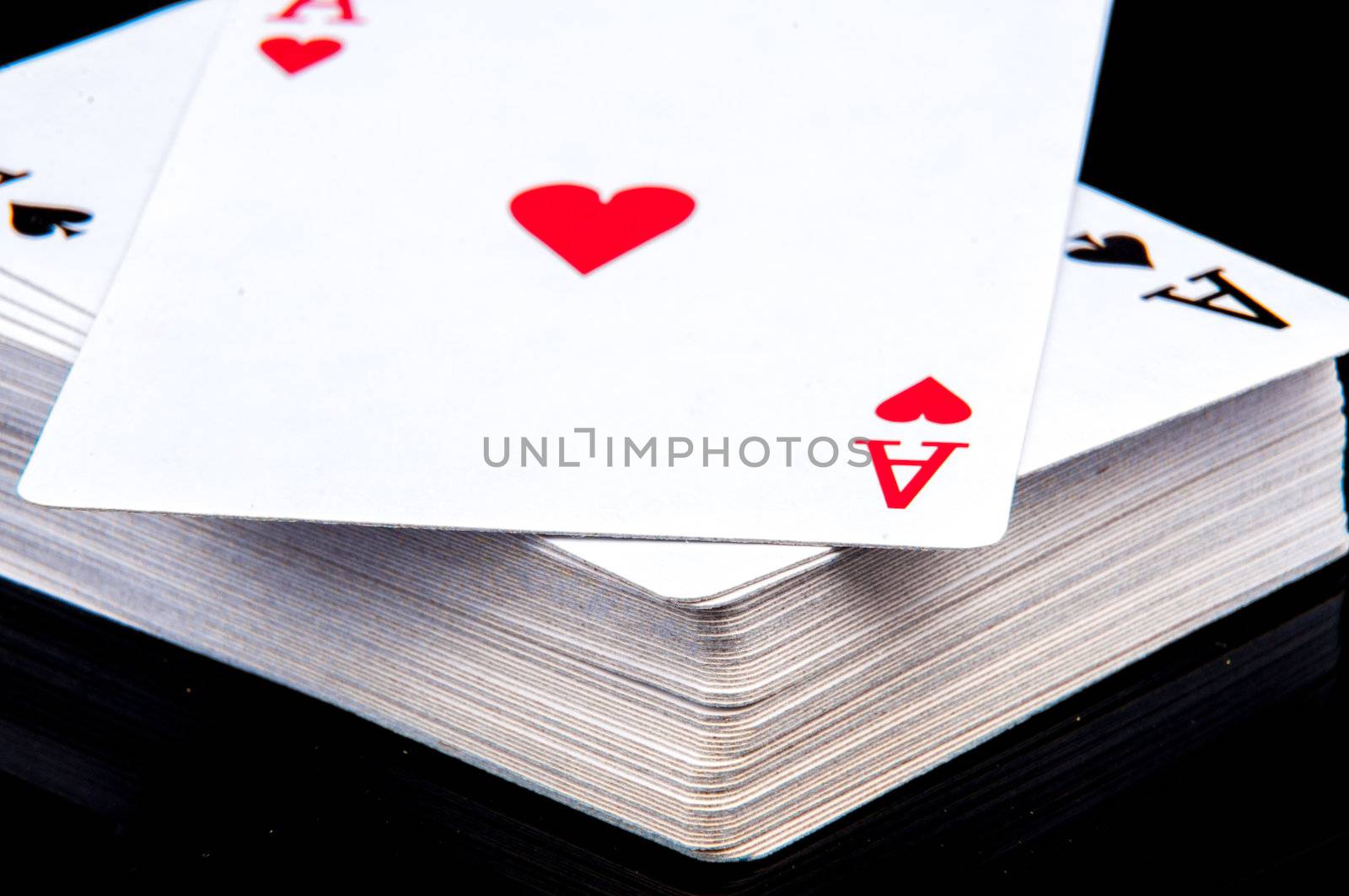 An image of playing cards, dice and money