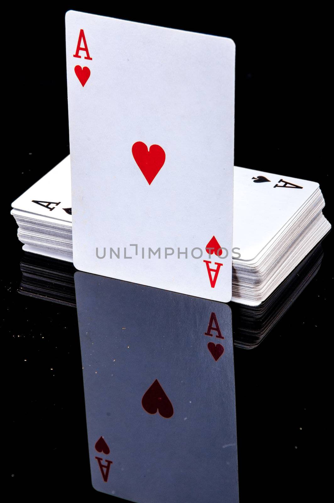 An image of playing cards, dice and money