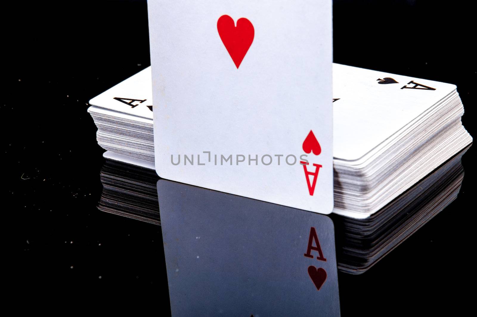 An image of playing cards, dice and money