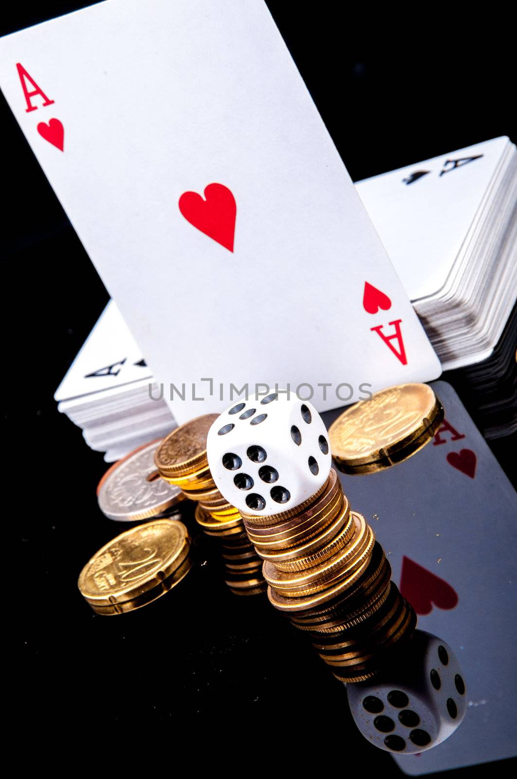 An image of playing cards, dice and money