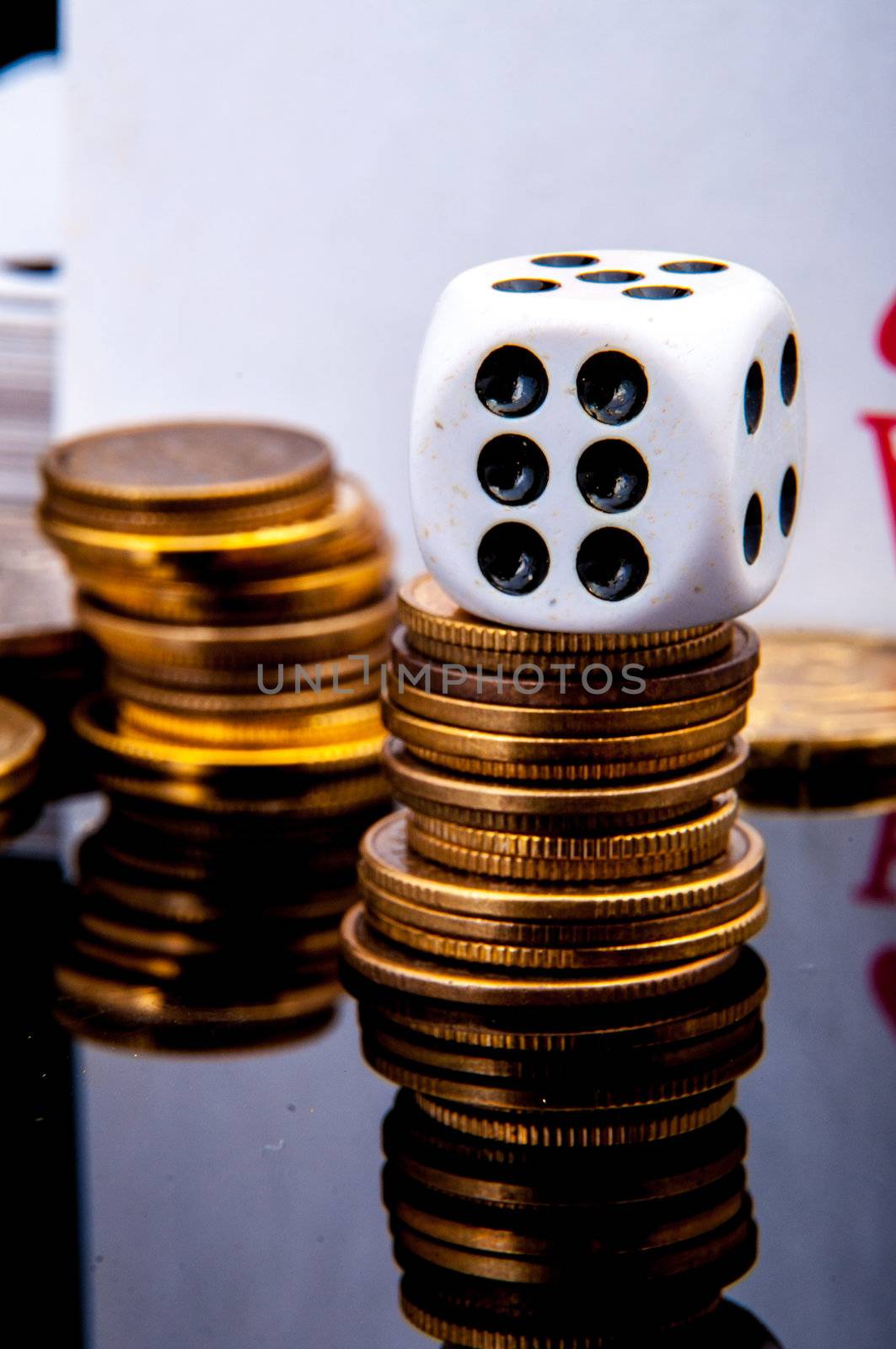 An image of playing cards, dice and money