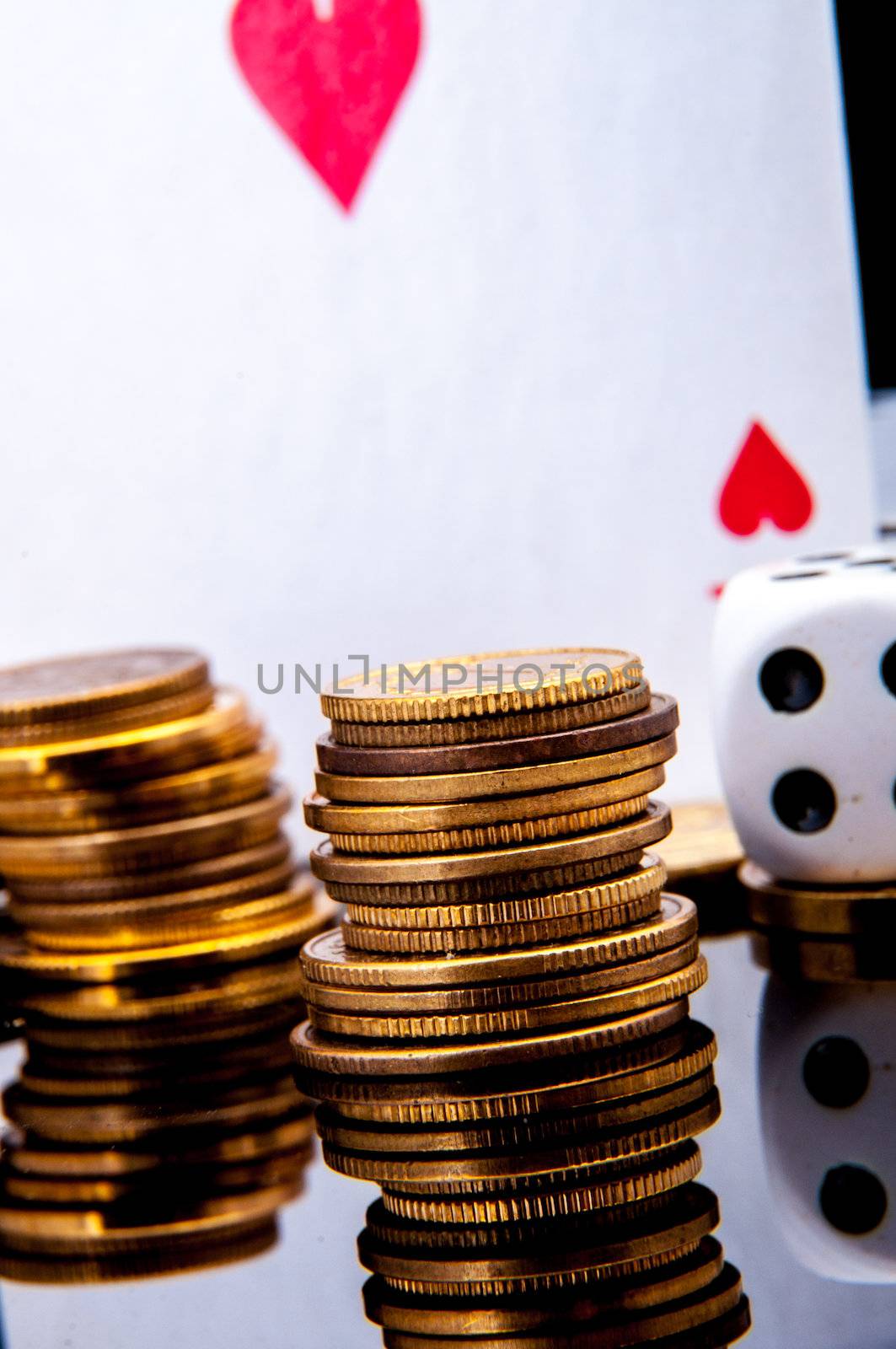 An image of playing cards, dice and money