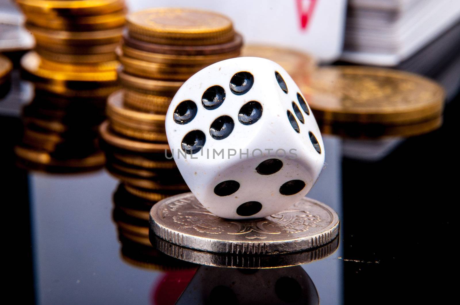 An image of playing cards, dice and money