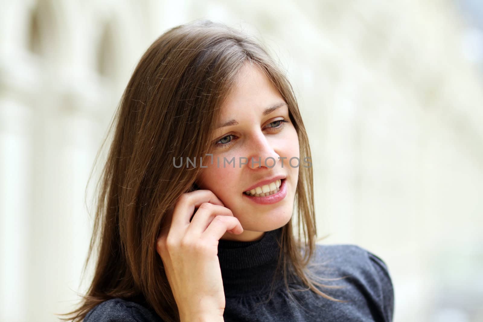 Young beautiful woman talking on cell phone