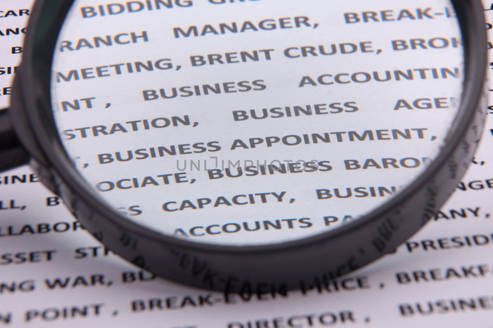An image of magnify glass over paper with written business slang