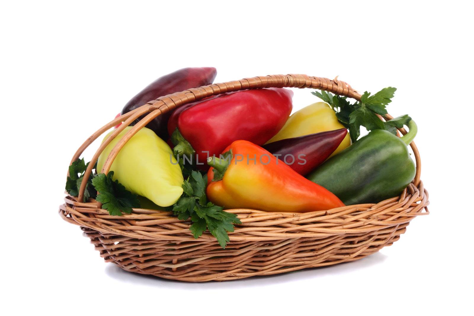Red, yellow and green pepper in a basket on a white background. by georgina198