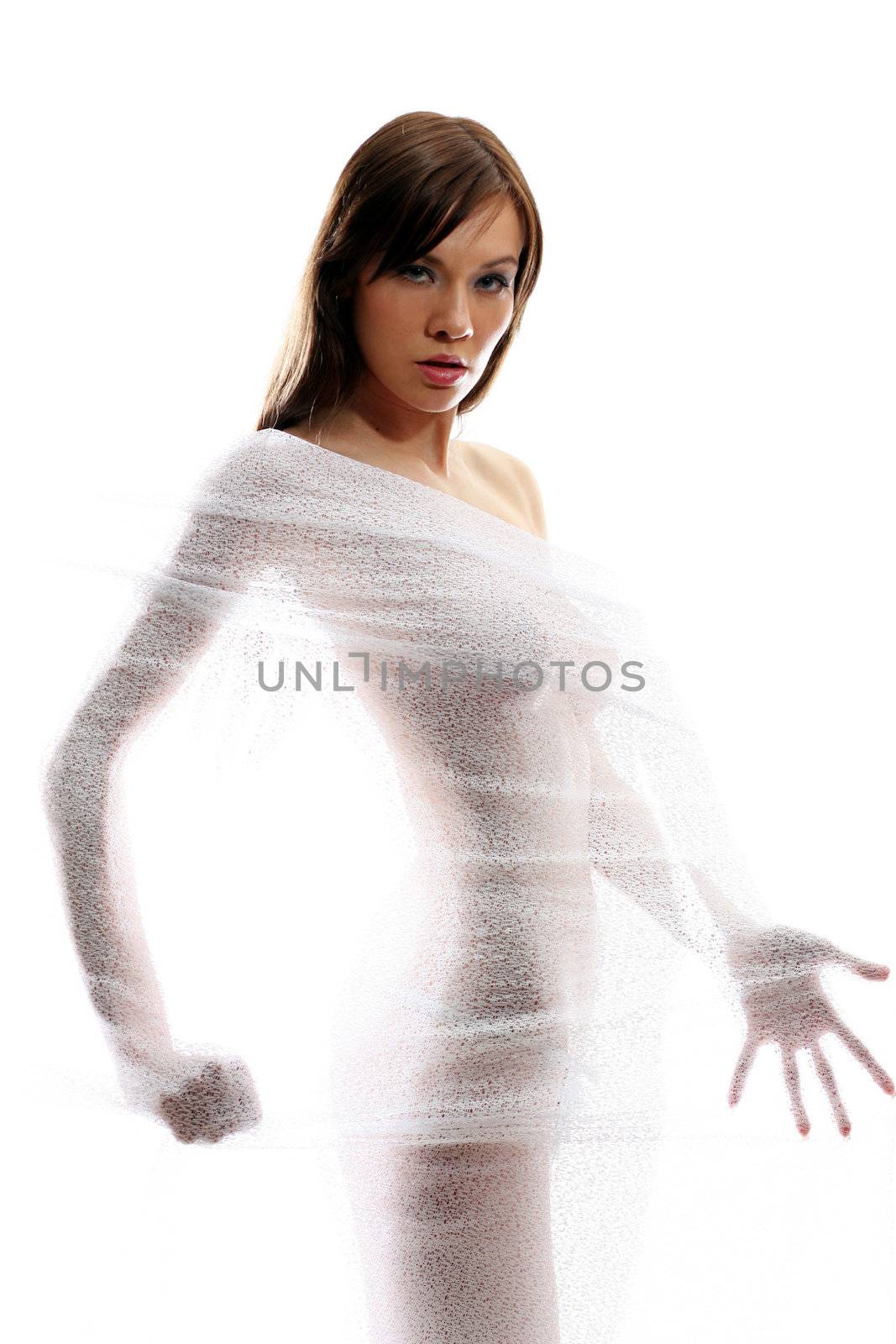 The body of a beautiful naked woman through the transparent fabric on a white background