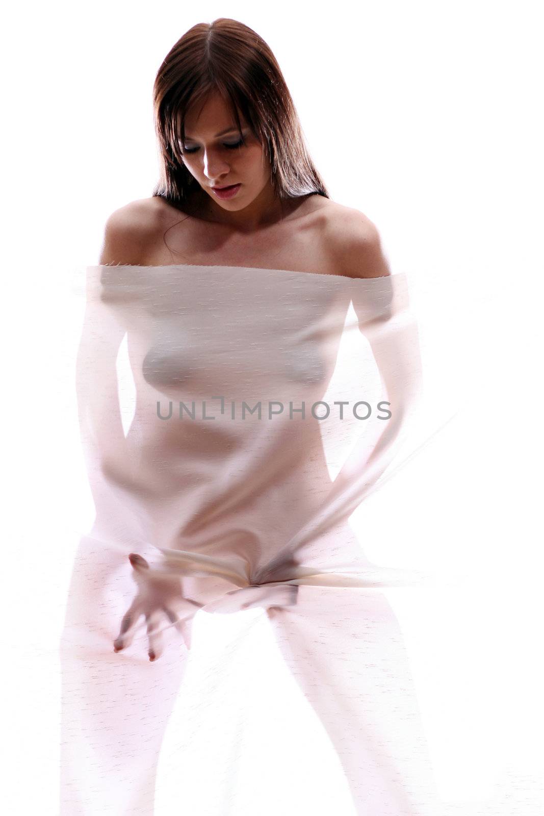 The body of a beautiful naked woman through the transparent fabric on a white background