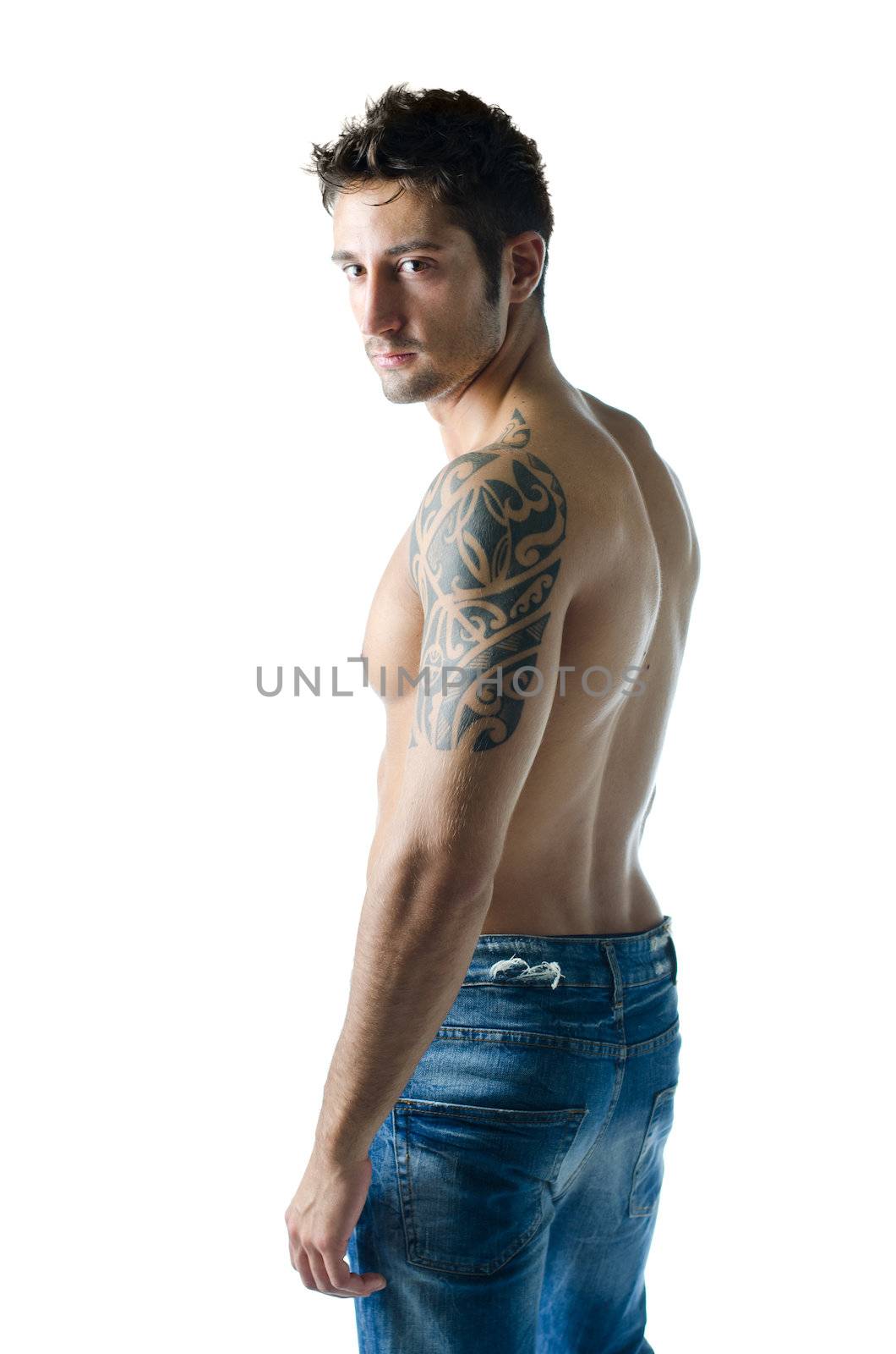 Profile shot of attractive and athletic young man shirtless, isolated on white