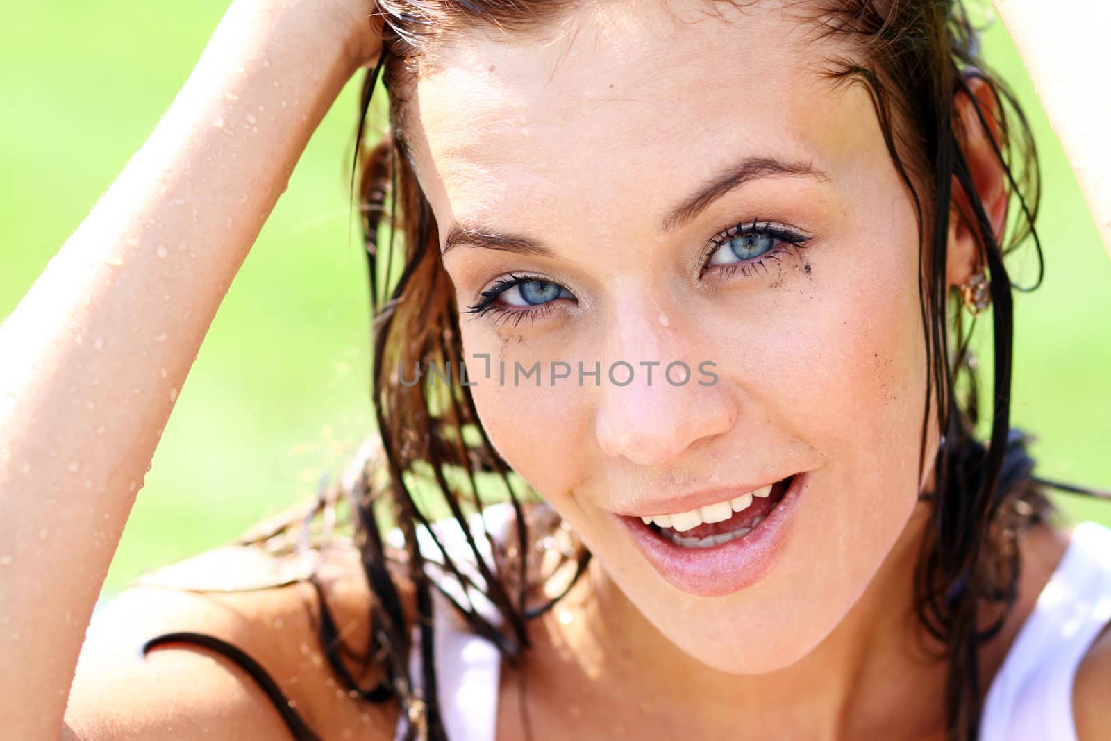 Young happy woman wet in the rain