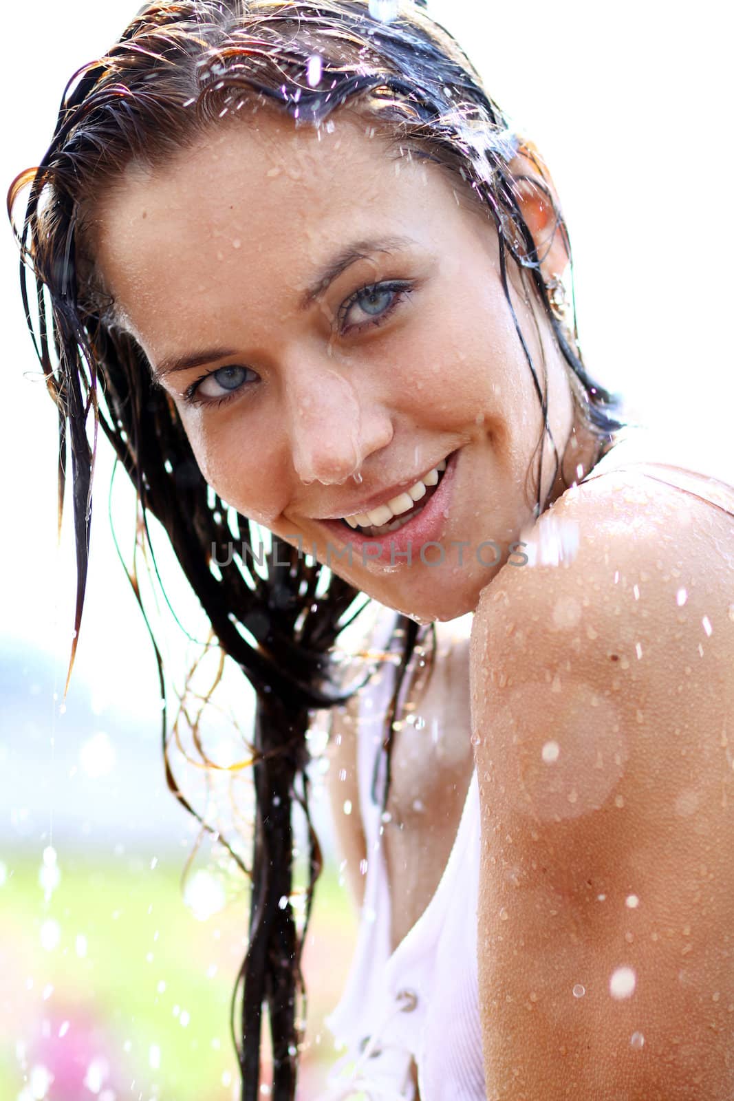 Young happy woman wet in the rain