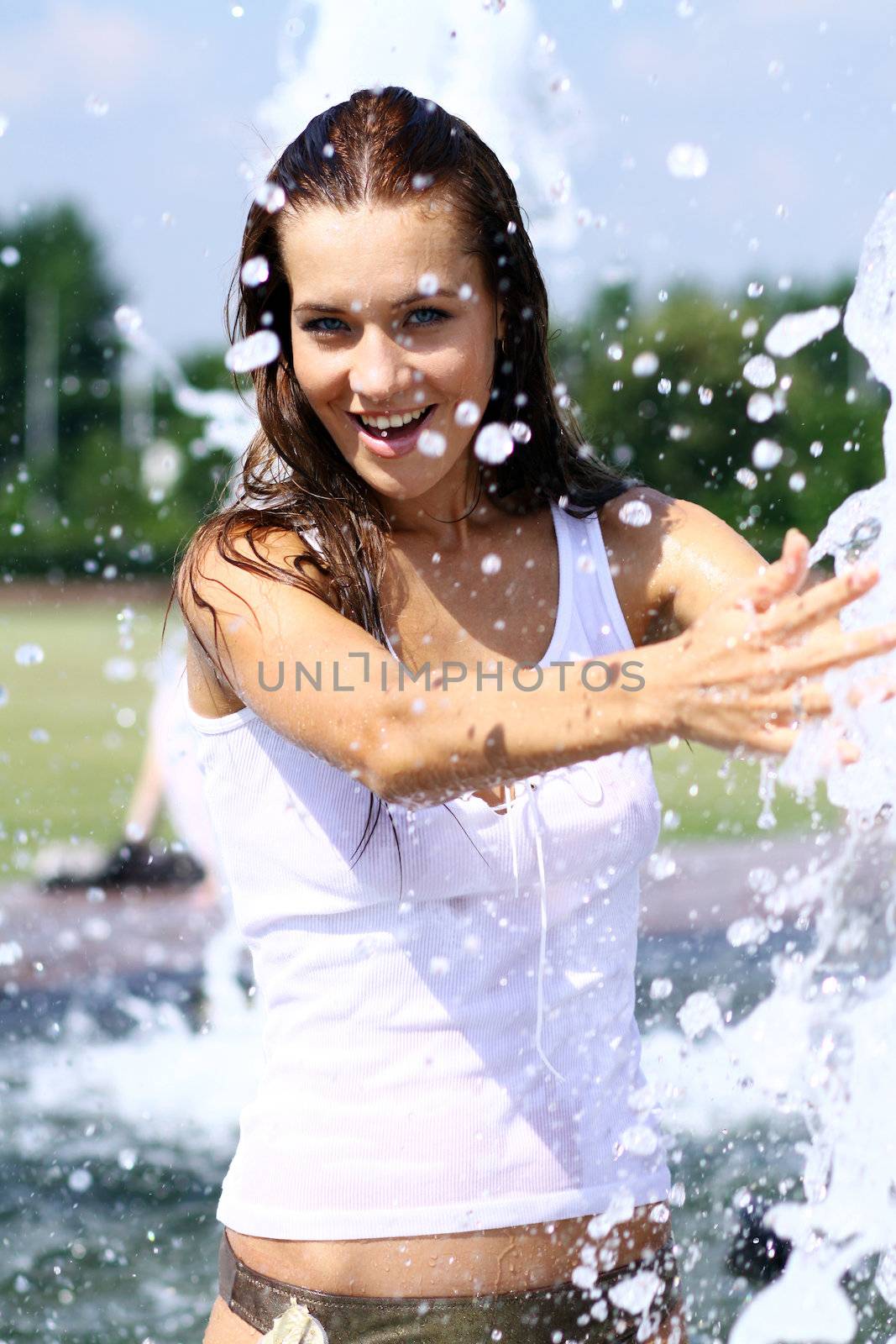 Young happy woman wet in the rain
