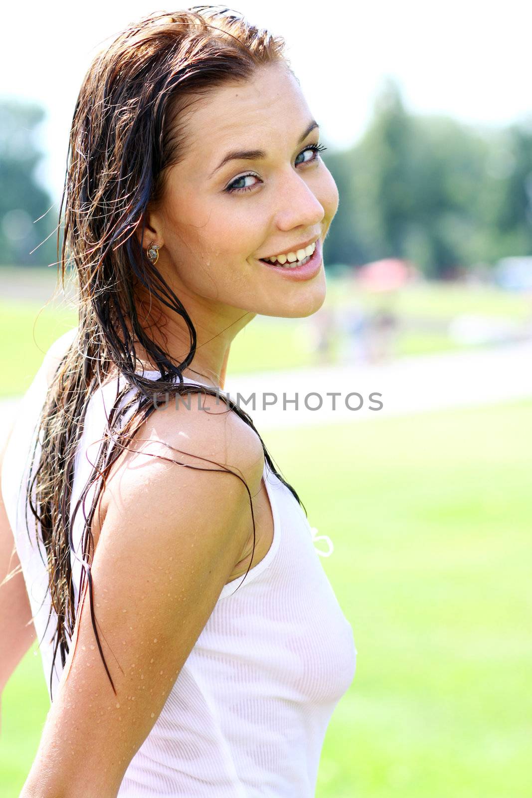 Young happy woman wet in the rain