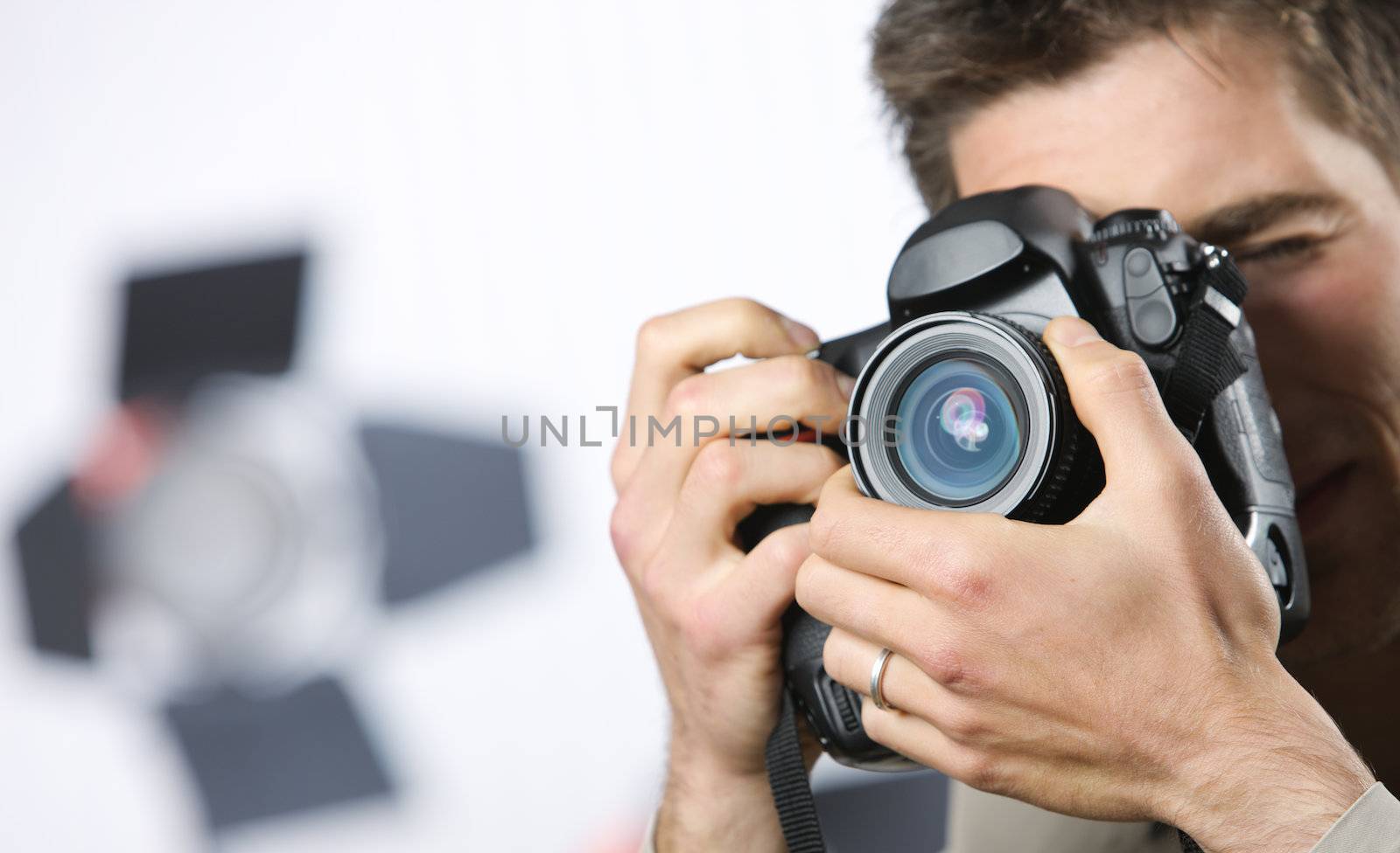 Young man taking photo with professional digital camera