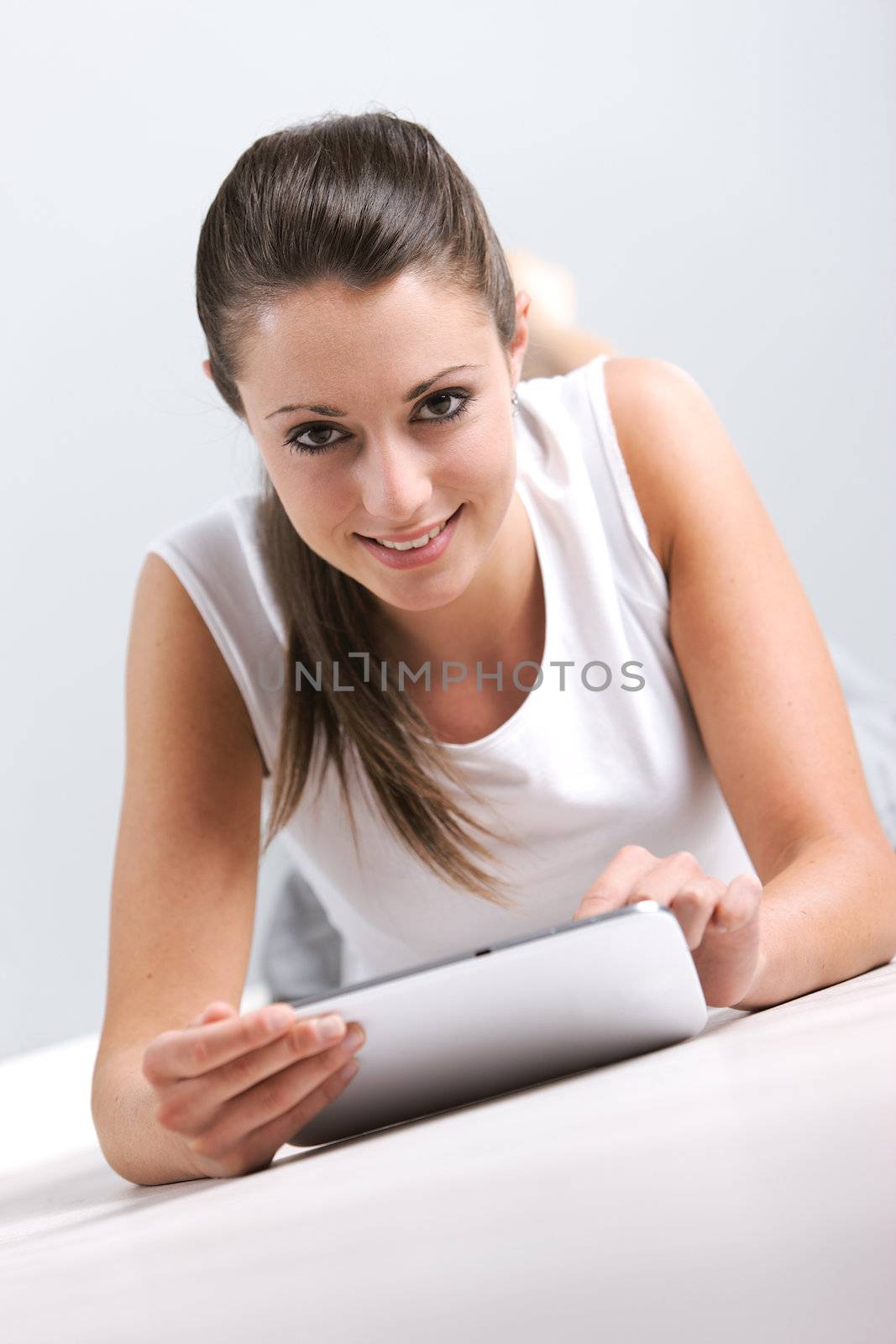 Portrait of smiling young woman whit her digital touchpad 