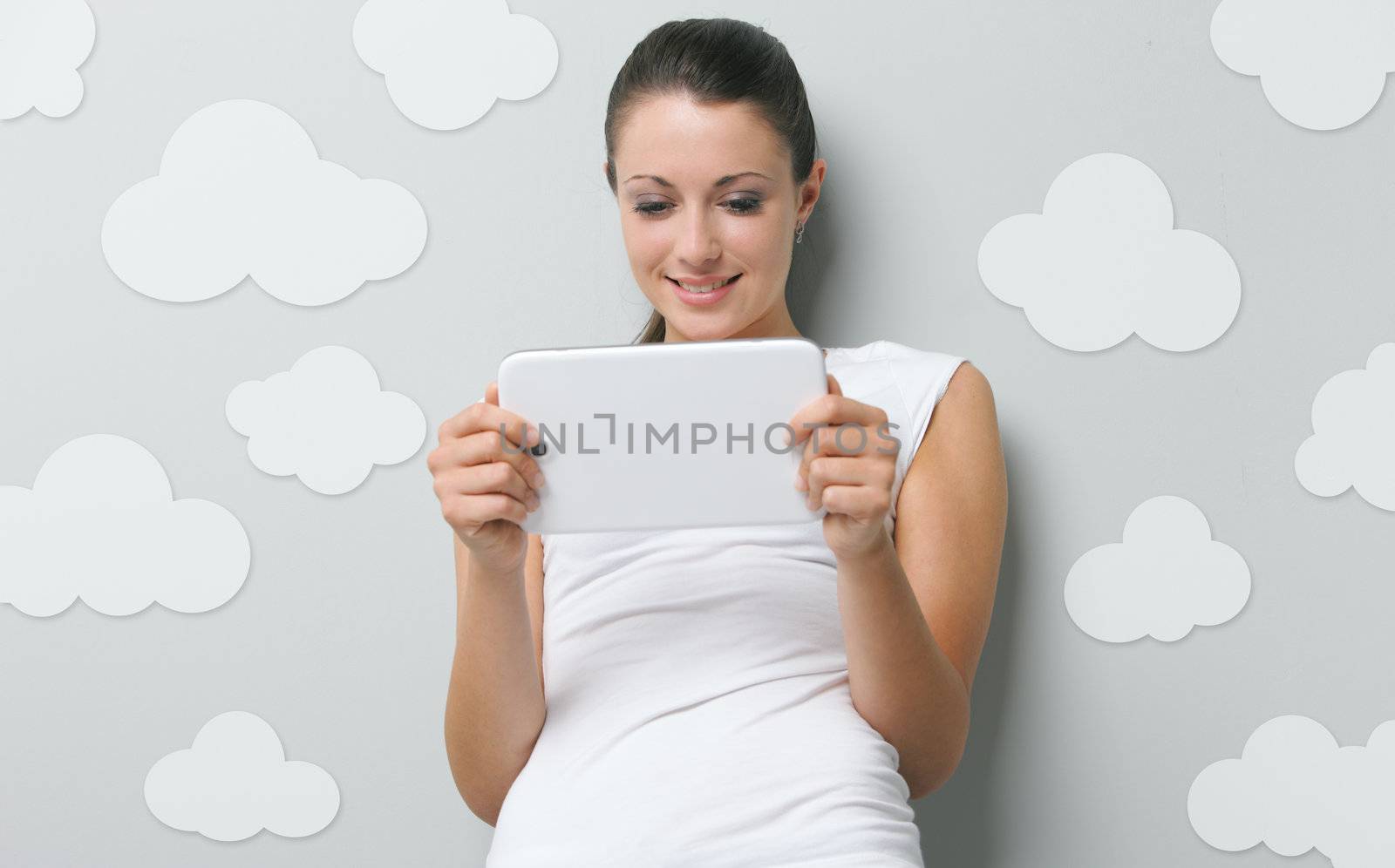 A beautiful young woman working on her digital touchpad 