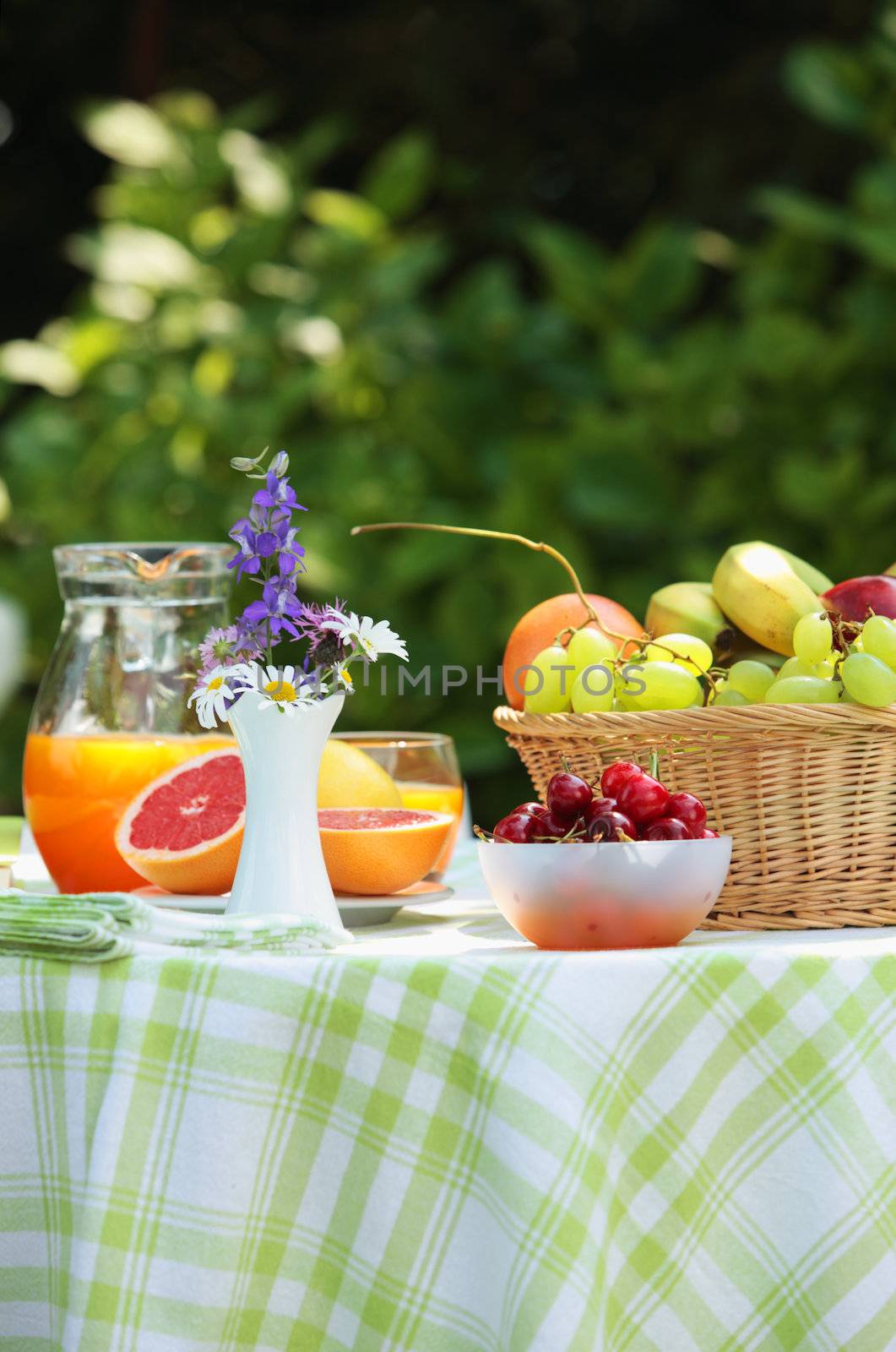 Close up of a table with fruit and orange juice