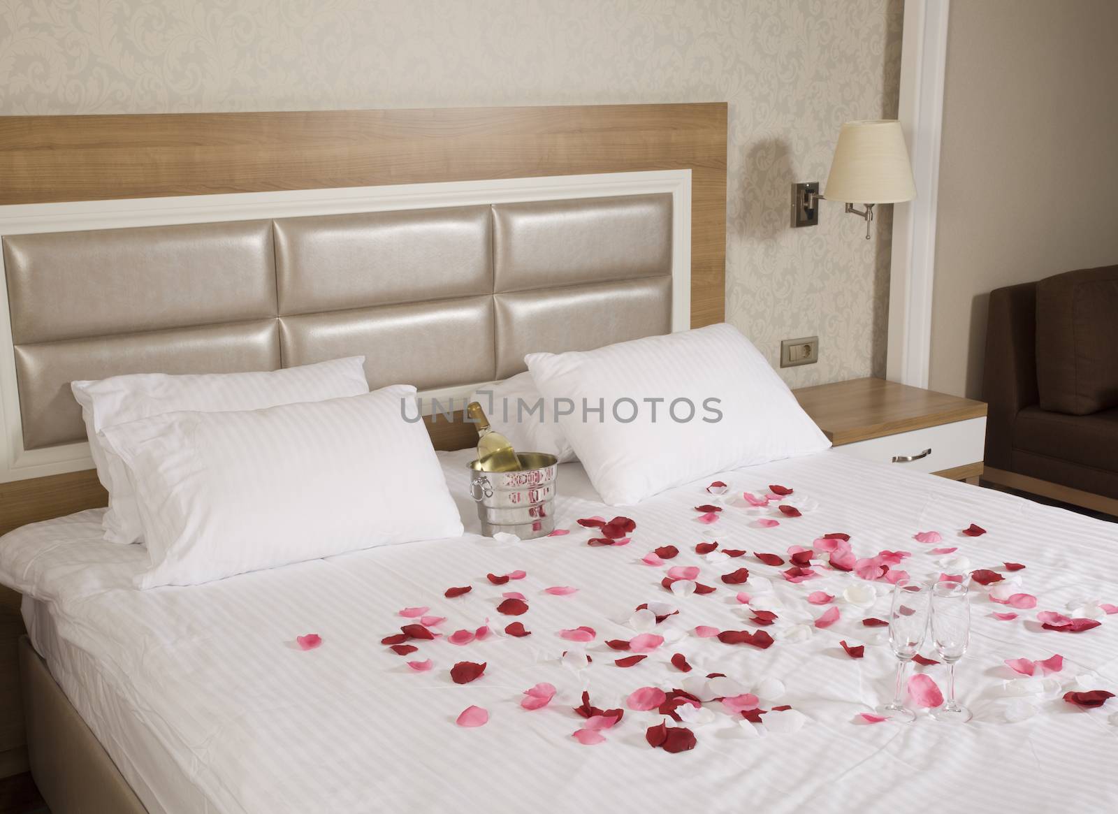 hotel room with big bed and red flowers by senkaya