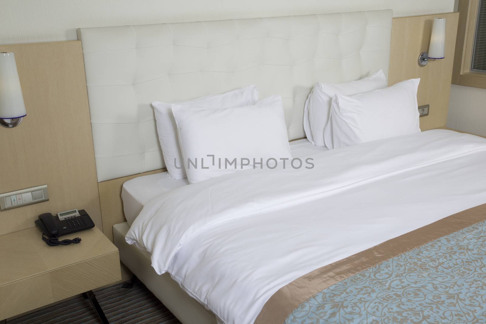 King sized bed in a luxury hotel room  by senkaya