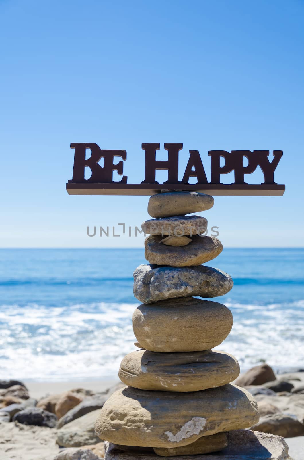 Sign "Be Happy" on balanced rocks by EllenSmile