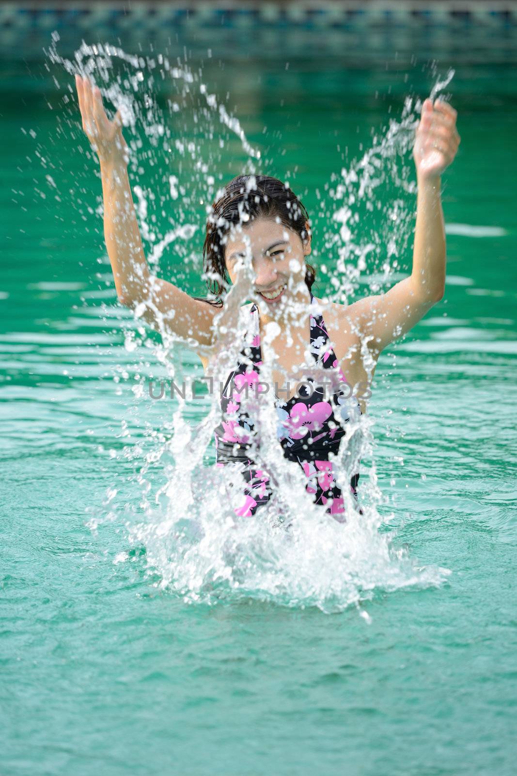 asian woman relaxing in the swimming pool