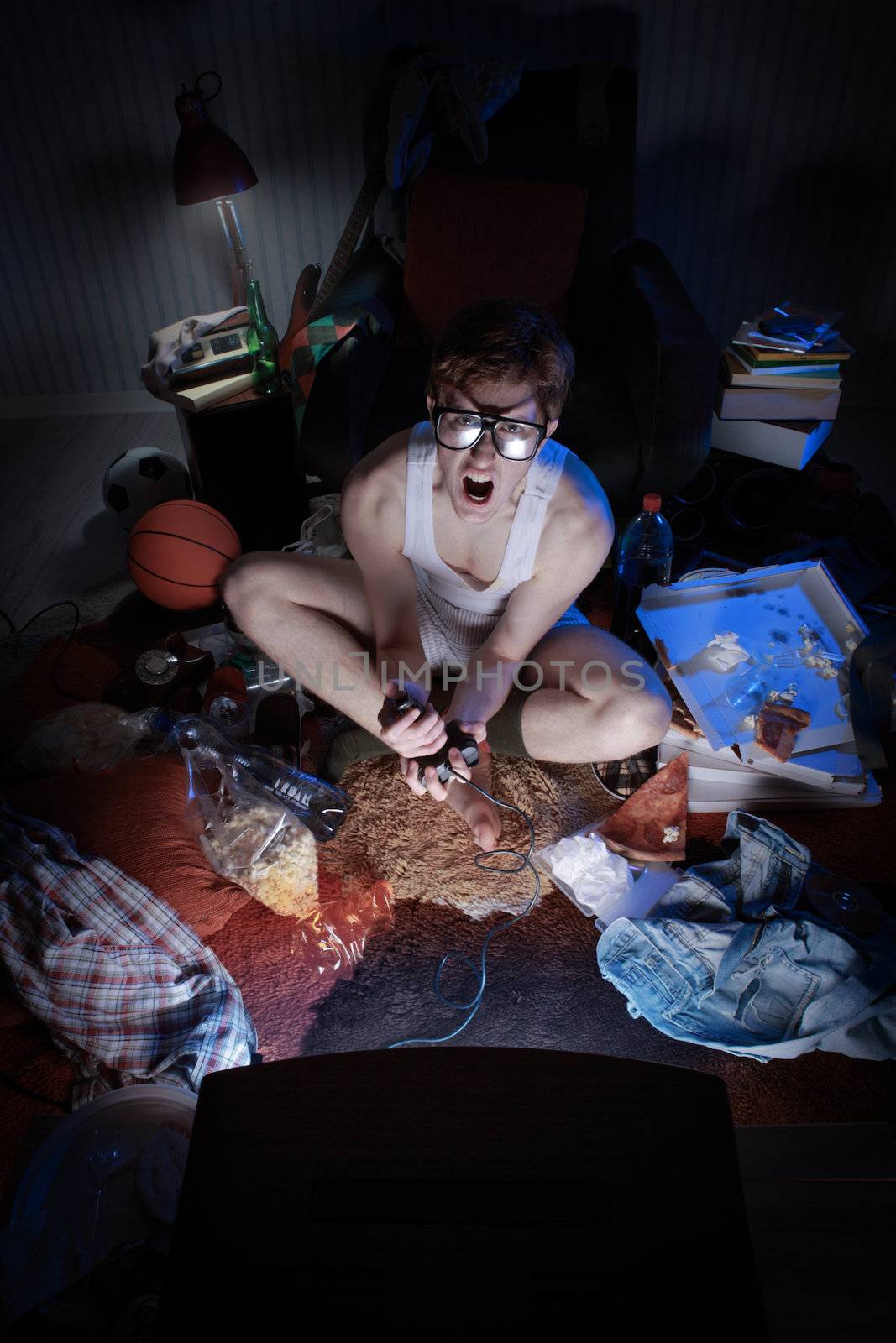A excited teen plays video console games on His television