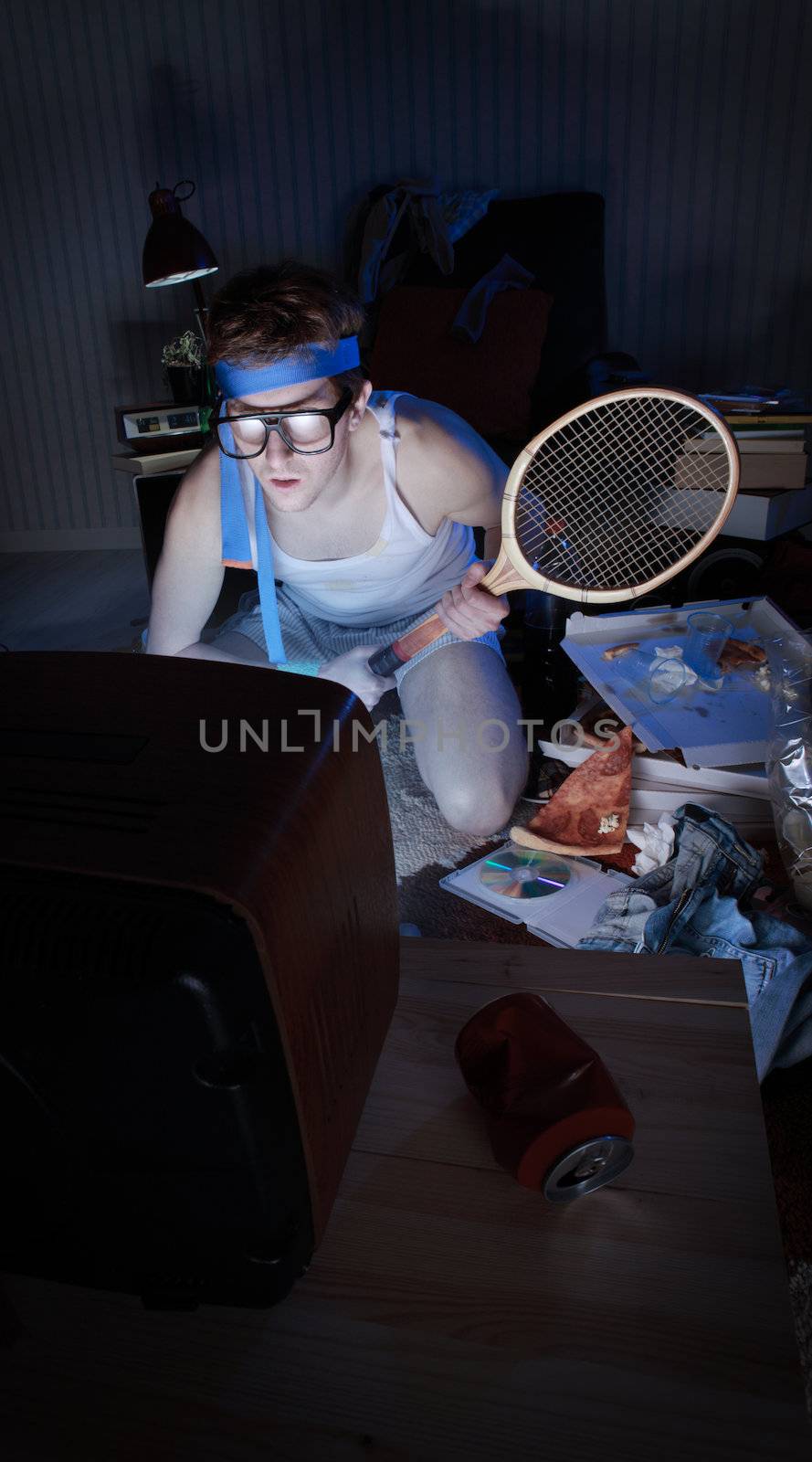 Young man tennis fanatic getting really into the tennis game on television