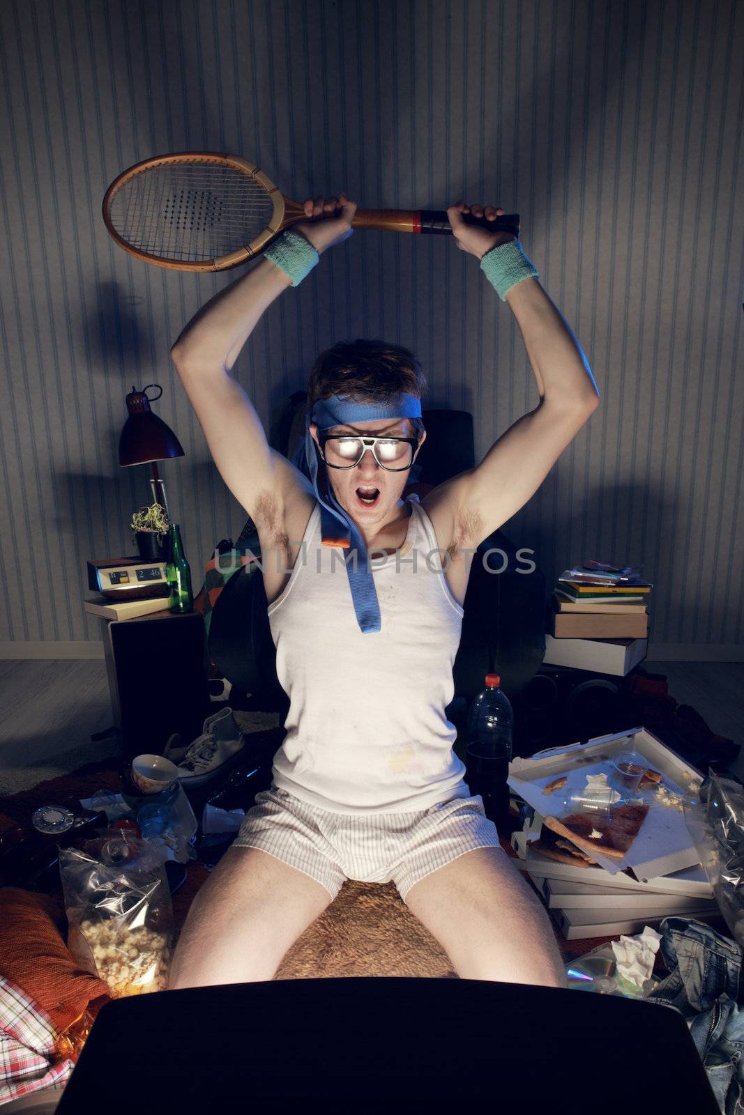 Young man tennis fanatic getting really into the tennis game on television