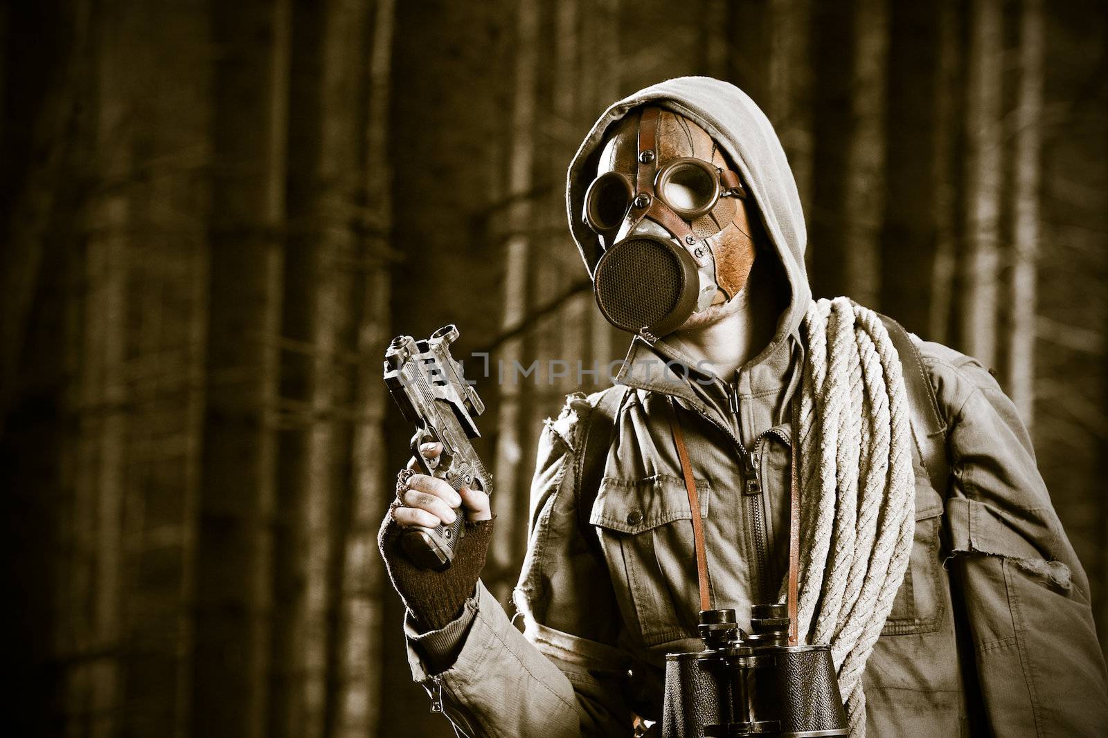 Soldier wearing a gas mask is fighting in a forest