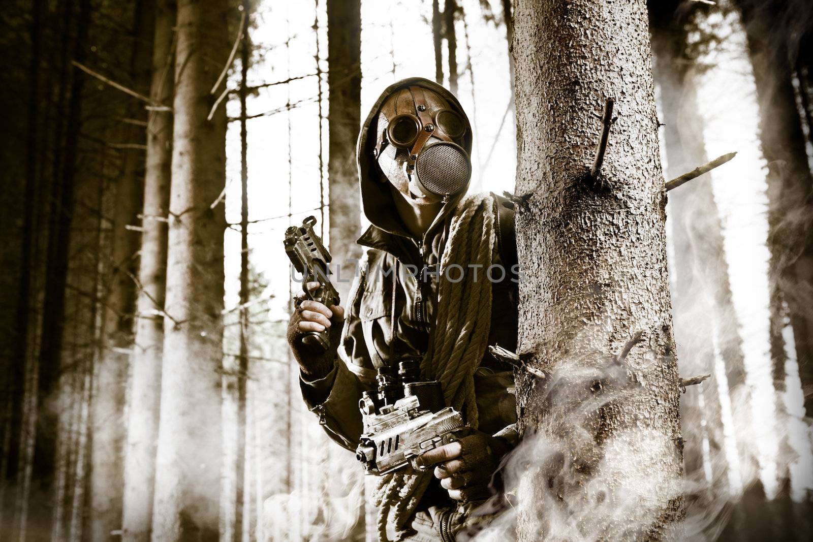 A soldier wearing gas mask is fighting in the forest