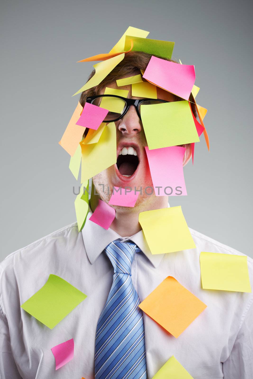 Office worker with post-its all over his face