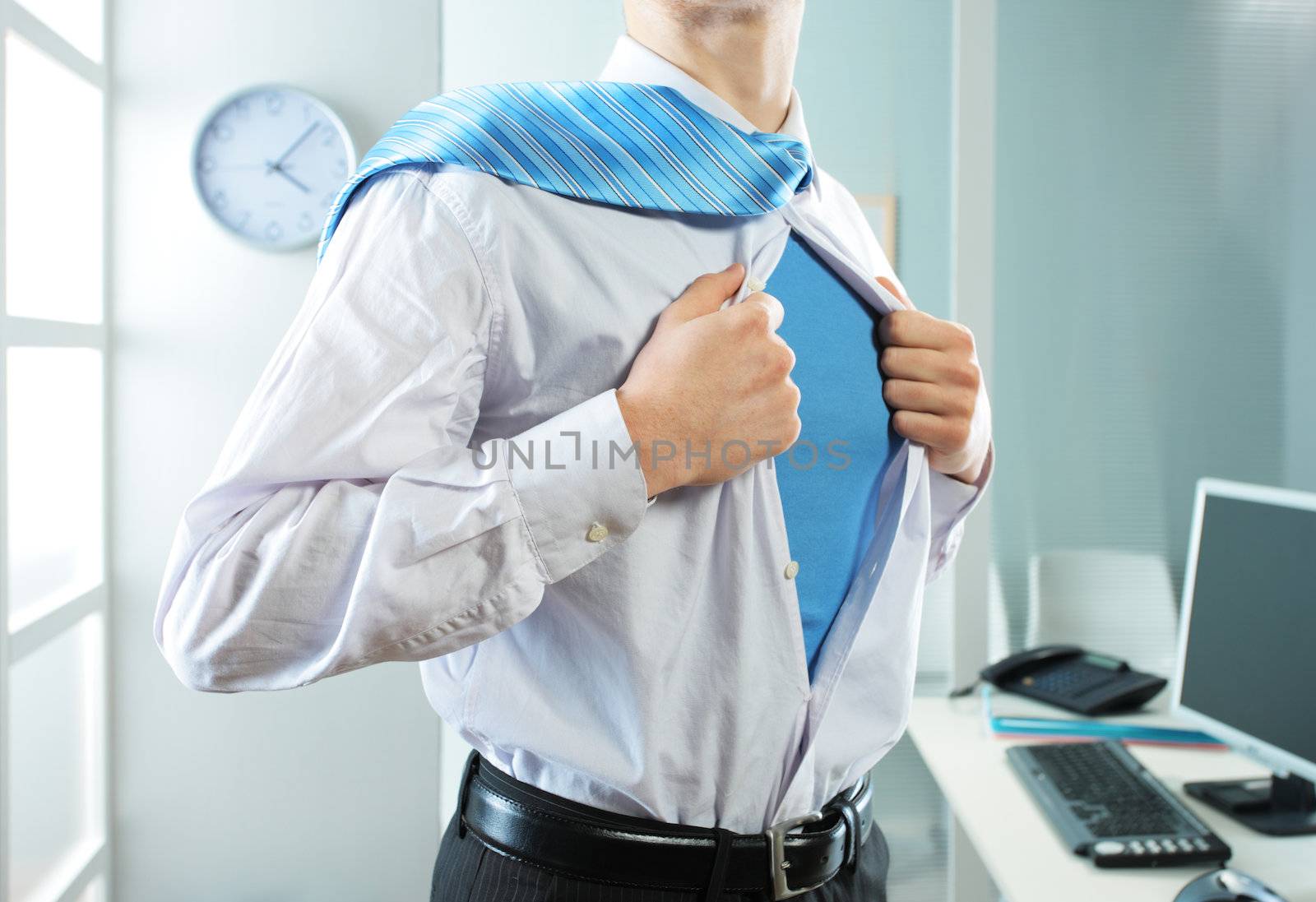 Superhero businessman pulls open shirt in his office