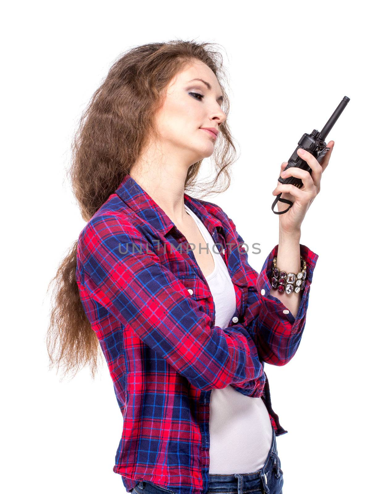 Attractive young woman in a checkered shirt with walkie talkie, isolated