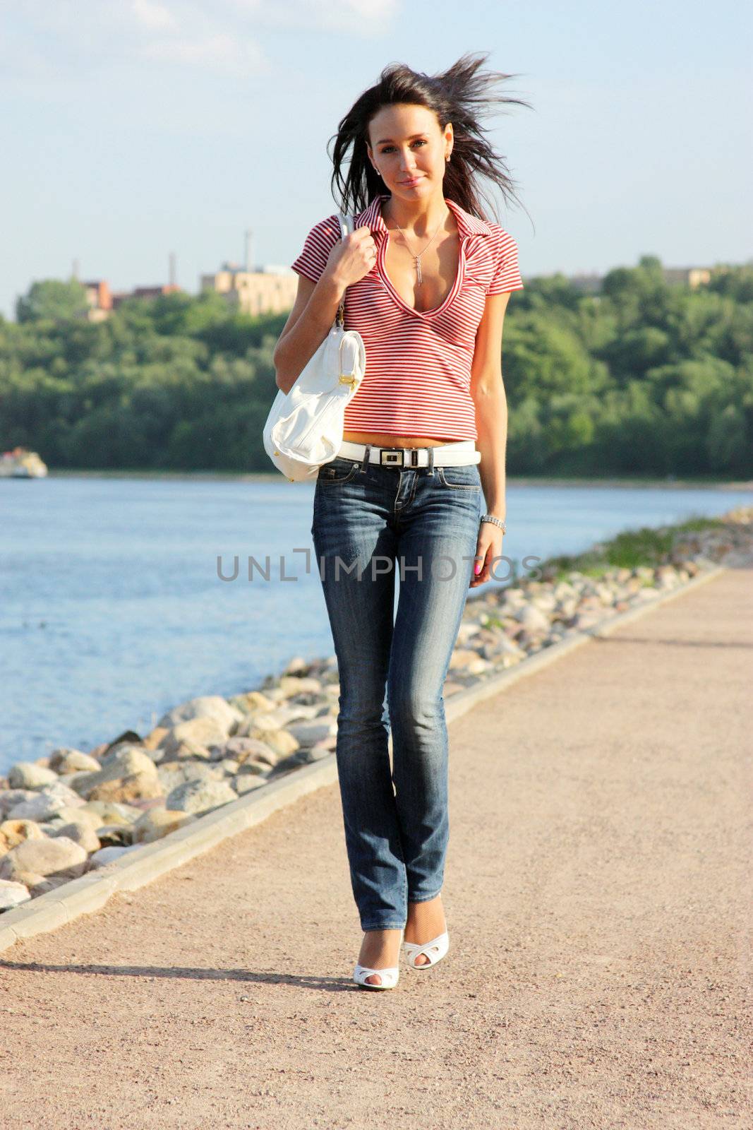 Full length portrait of a young lady walking outdoor