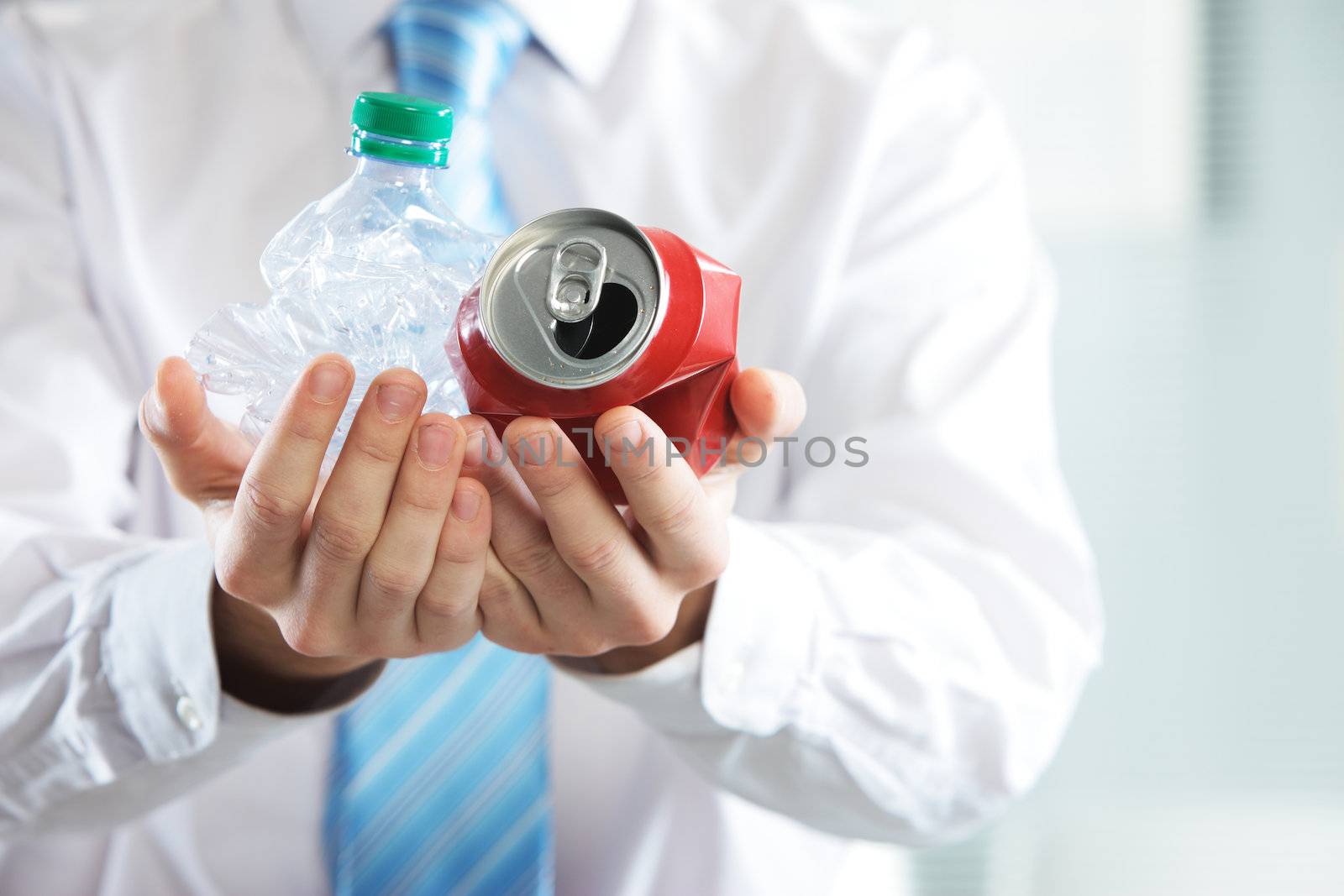 Businessman holding a crashed bottle and drink can, Recycle concept