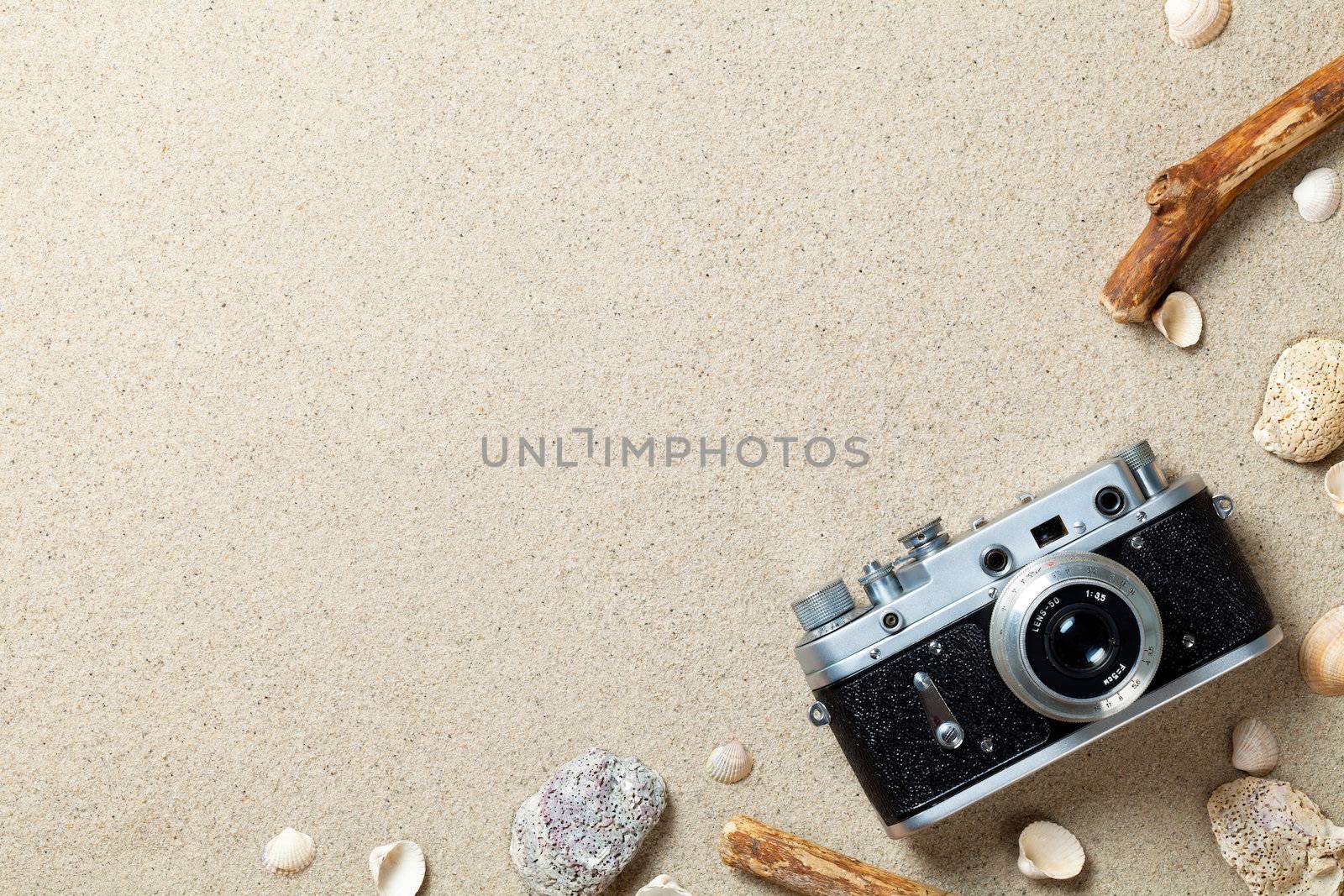 Sand background. Sandy beach texture. Summer concept with old retro camera. Top view