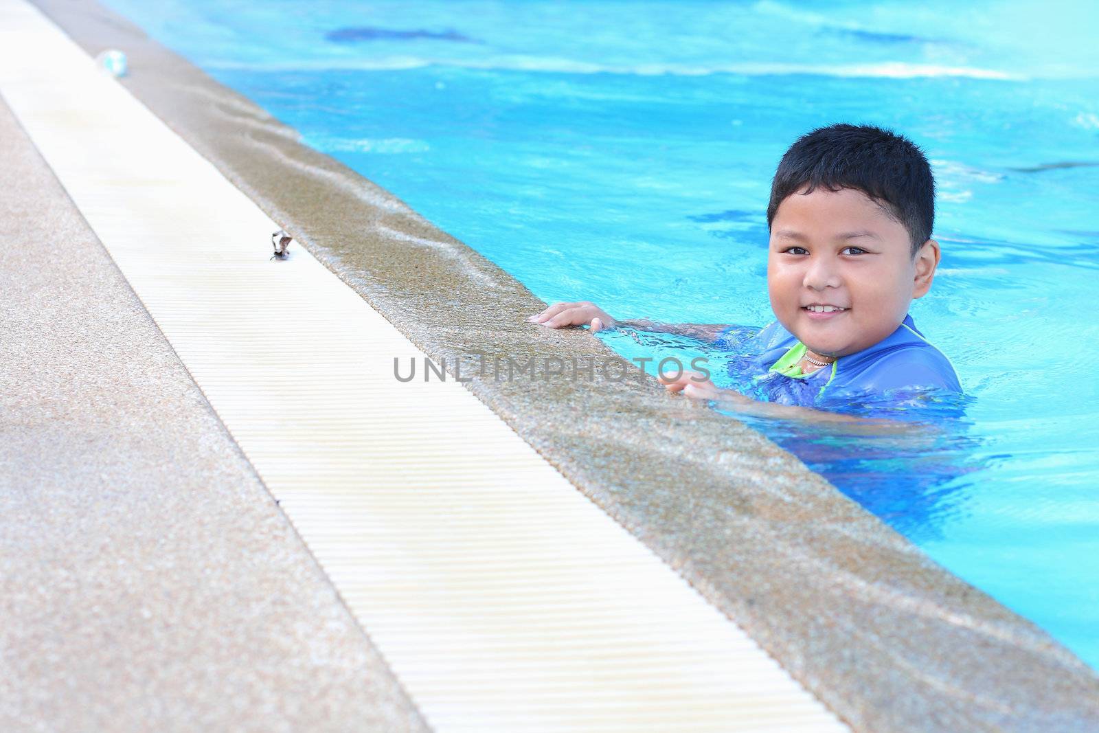 The boy was swimming in the pool. by myrainjom01