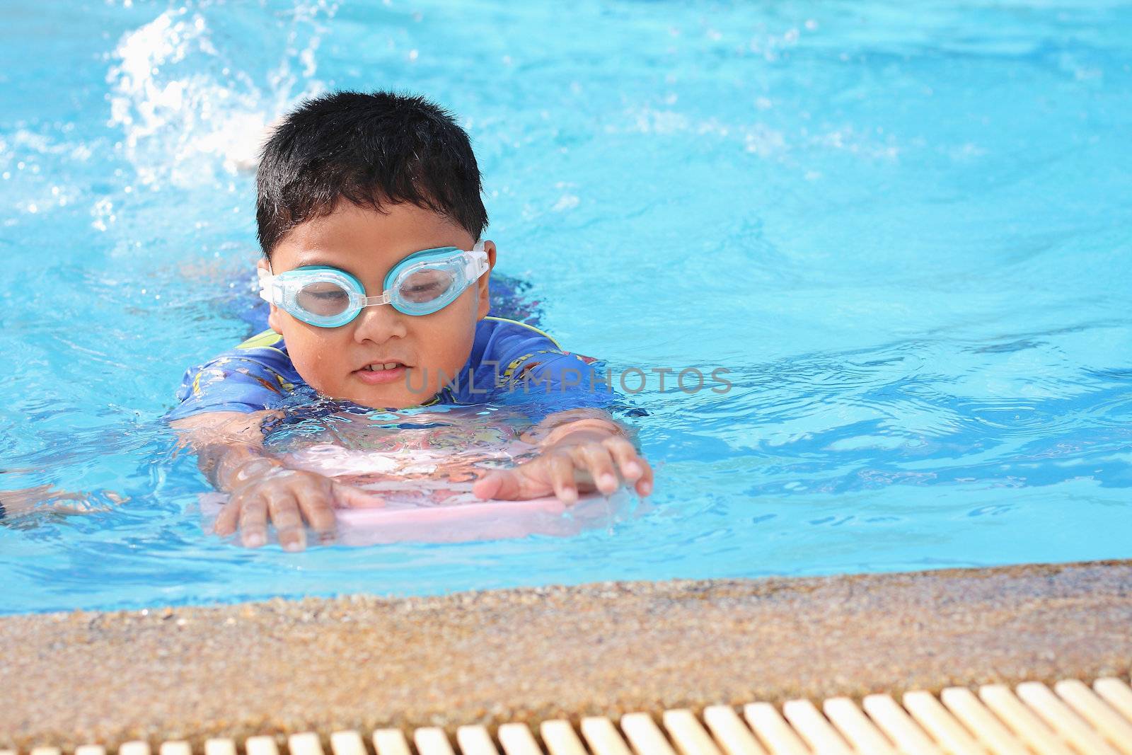 The boys were playing in the swimming pool.