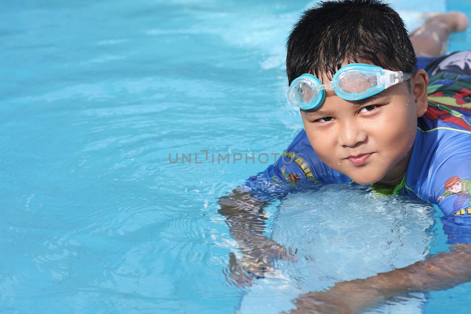 The boys were playing in the swimming pool.