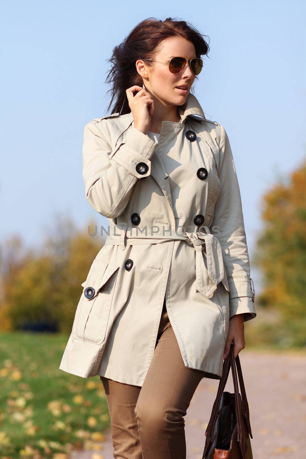 Full length, walking woman in autumn park