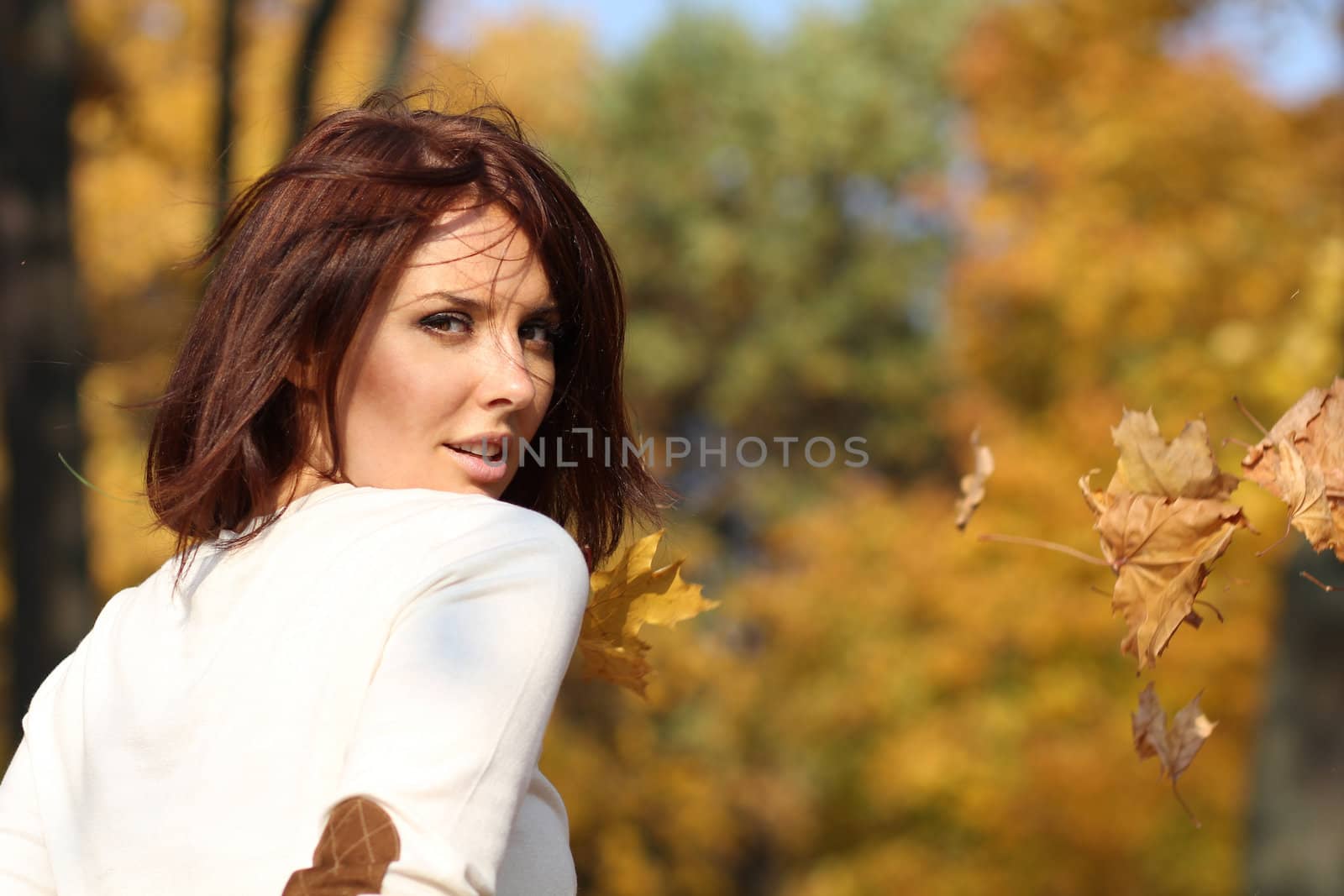 Portrait of a happy woman against yellow leaves