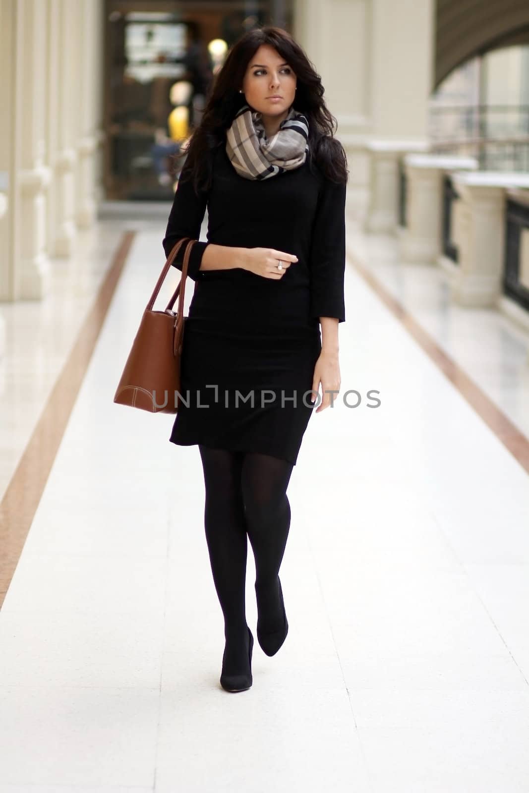 beautiful young woman waling in the shop
