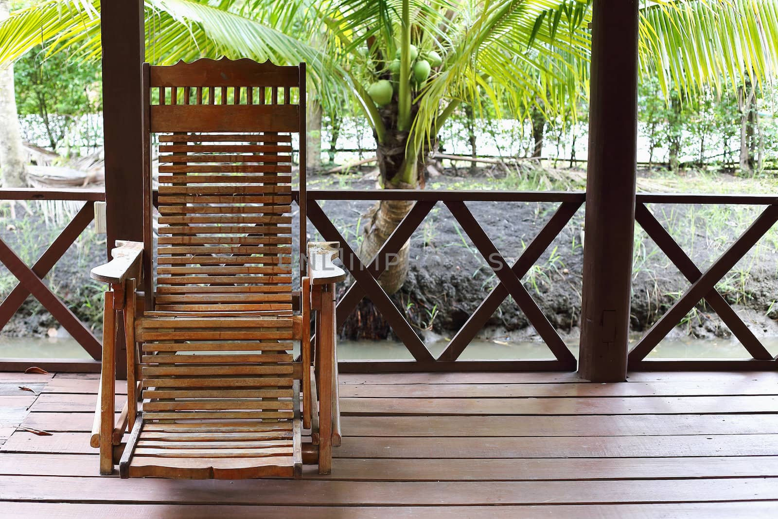 wooden chairs on a patio in the garden by myrainjom01