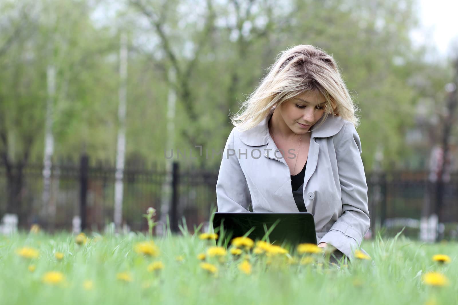 young blond with laptop outdoors