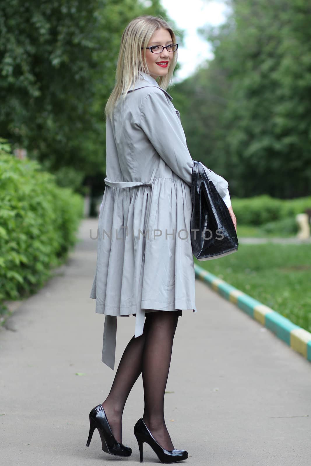 beautiful young woman business woman in a gray cloak